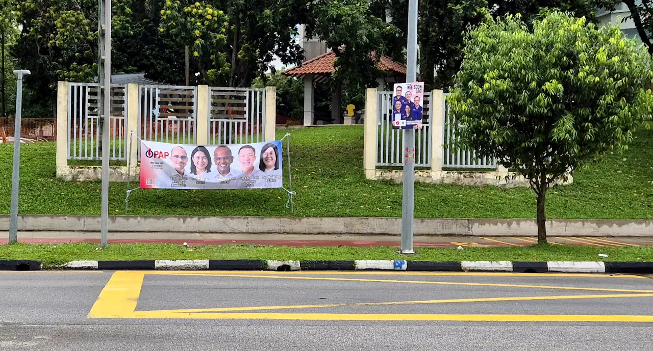 A banner along the road-side and a poster on the lamppost @ Chong Pang